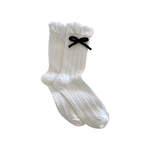 White cable knit socks with ruffled bubble cuffs and black bows for a Japanese style look