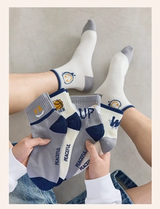 Detail of cotton crew socks with ribbed cuffs and retro athletic graphics