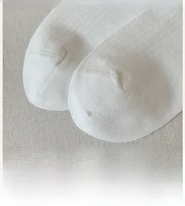Detail shot of flat seamless toe and breathable white cotton knit fabric texture