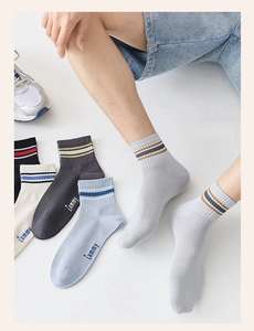 Detail of cotton crew sports socks with rib cuffs, stripes, and Tammy logo embroidery