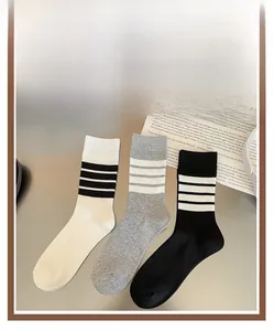 Detailed top view of striped cotton crew socks set in white, grey, and black colors