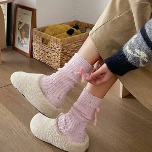 Pink cashmere wool socks with cute heel bow and speckled yarn for winter warmth