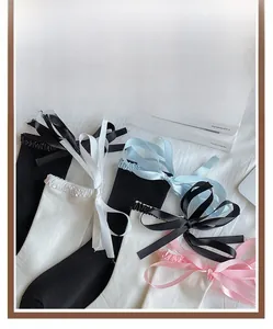 Detail of sweet Lolita crew socks featuring wide silk ribbons in various pastel colors