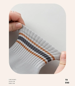 Detail showing the high elasticity ribbed cuff of the striped grey cotton athletic socks