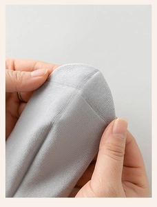 Close-up of light grey striped sports socks showing toe seam detail and knit elasticity