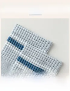 Close-up of high-elasticity ribbed cuff on blue striped breathable cotton sports socks