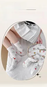 Detail of soft cotton crew socks showing cartoon cat and sheep patterns with flat seams