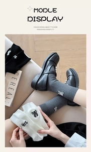 Detailed close-up of ribbed socks with delicate bow and Sweet Candy embroidery