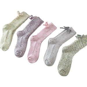 Five pairs of kids knit crew socks with bows in beige, purple, pink, grey and green