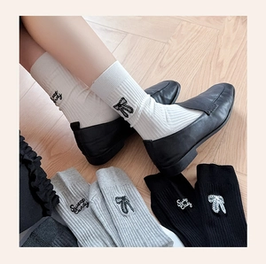 Detailed embroidery of Sweet Candy lettering and bow on ribbed cotton crew socks