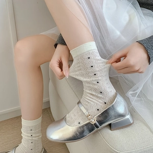 Cream mesh crew socks with black polka dots and silver Mary Jane shoes with pearls