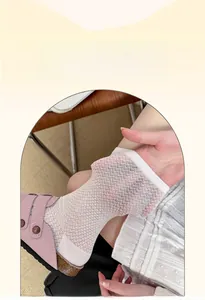 Detailed view of white mesh crew socks showing breathable knit texture with pink sandals