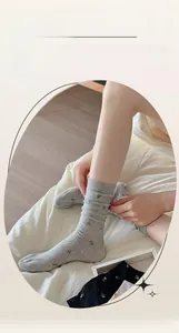 Detail of grey floral mesh socks featuring breathable silk-cotton blend and flower pattern
