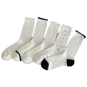 Set of five white breathable mesh crew socks with hollow patterns and retro wavy edges