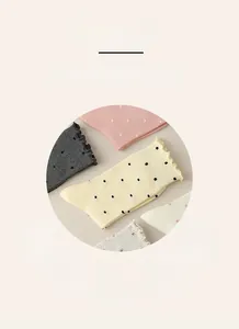 Detailed close-up of retro polka dot cotton socks with vintage scalloped edge finish
