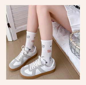 Close-up of white cotton socks with cute cartoon sheep pattern and Cool Sheep text