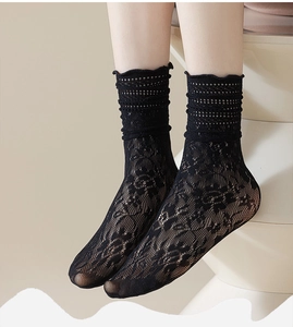 Detailed view of black floral lace mesh crew socks with vintage scalloped edge design