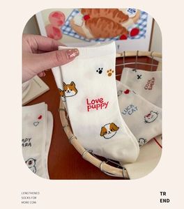 Close-up of white cotton crew socks featuring cute embroidered cartoon animal details