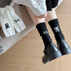 Women's crew socks featuring sweet bow embroidery and lettering in black and white