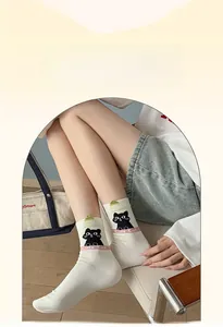 Detail of white cotton mid-tube socks featuring a cute black cat and Cute Cat text