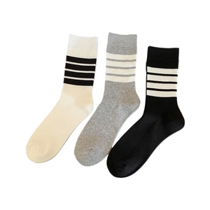Three pairs of striped mid-calf cotton socks in white, gray, and black colors