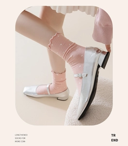 Pink polka dot socks with ruffled cuffs paired with silver metallic Mary Jane shoes