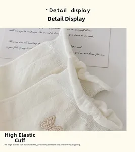 Detailed close-up of white ruffled socks with delicate brown butterfly embroidery on the side