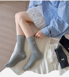 Close-up of ribbed cotton socks with bow embroidery in various classic colors