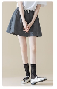 Detail of ballet style mesh socks with black lace floral pattern and Mary Jane shoes