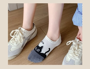 Detail shot of white and grey low cut invisible socks with cute black cat pattern and text