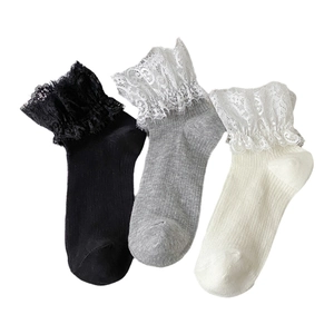 Lace trim socks in black, grey, and white with elegant floral ruffles in flat lay view