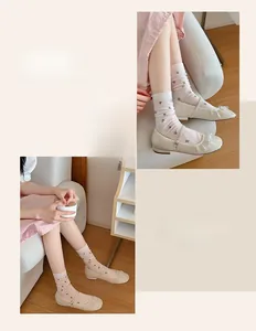 Detail of floral mesh cotton crew socks paired with pearl embellished Mary Jane flats
