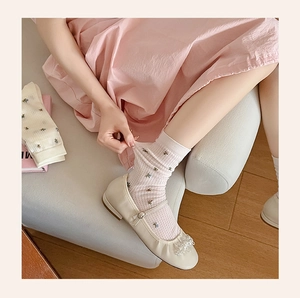 Detailed close-up of floral embroidery on breathable cotton mesh crew socks for women