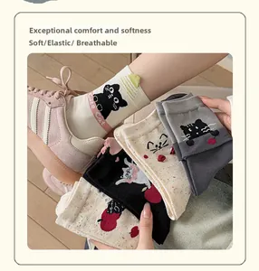 Detailed close-up of cute cat embroidered mid-calf socks with soft cotton texture