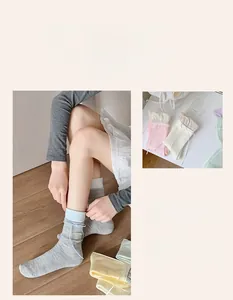 Detail of sweet ballet core crew socks featuring delicate light blue ribbon bow decoration