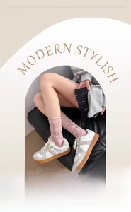 Detailed view of pink cotton mid-tube socks with white heart jacquard and wavy patterns