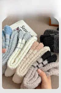 Close-up of thick coral fleece winter socks showing soft plush texture and striped patterns