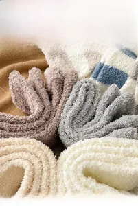 Detail shot of thick coral fleece fabric showing soft texture and warm striped patterns