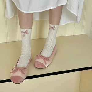 Sweet balletcore style white lace socks with bows paired with pink ballet flat shoes