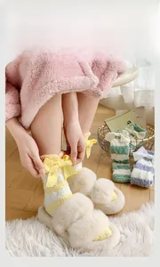 Détail de chaussettes épaisses en polaire corail à rayures avec nœud pour l'hiver