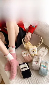 Detailed view of cute cartoon cat embroidery on fluffy thermal coral fleece socks