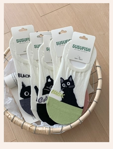 Detail of cute cat pattern invisible socks in a rustic basket for women's summer fashion