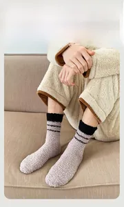 Detail of thick fuzzy coral fleece socks with stripes, warm loungewear for men