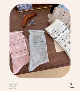 Detailed knit patterns of bowknot and heart motifs on soft vintage cotton mid-calf socks