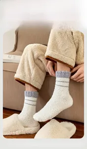 Men's thermal coral fleece socks with blue stripes shown with slippers in home setting