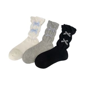 Three pairs of sweet bow socks in beige, grey and black with stylish ruffled cuffs