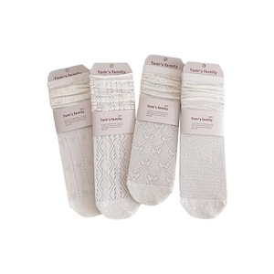 Set of four beige mid-calf socks with intricate floral and mesh knit patterns