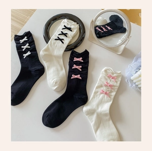 Detail of sweet ballet style socks with velvet bows and vertical ribbed texture
