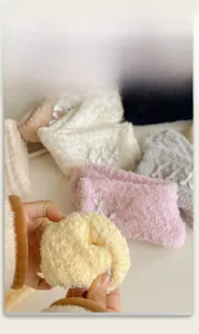 Close-up of elastic coral fleece winter socks with cute ribbon bow detail and soft texture