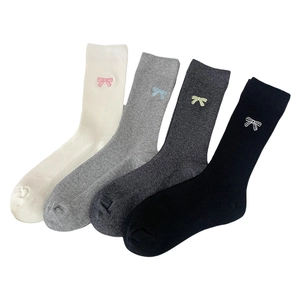Set of four cotton crew socks with embroidered bows in white, grey, and black